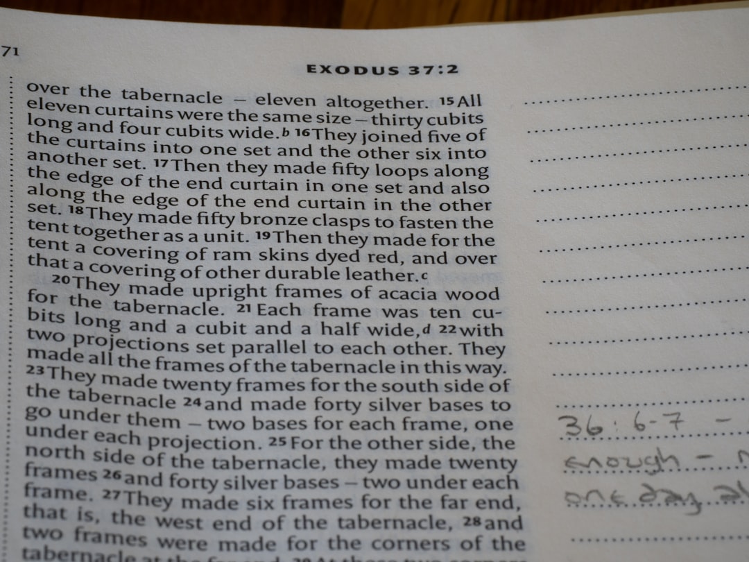 Close-up of an open bible page with text.