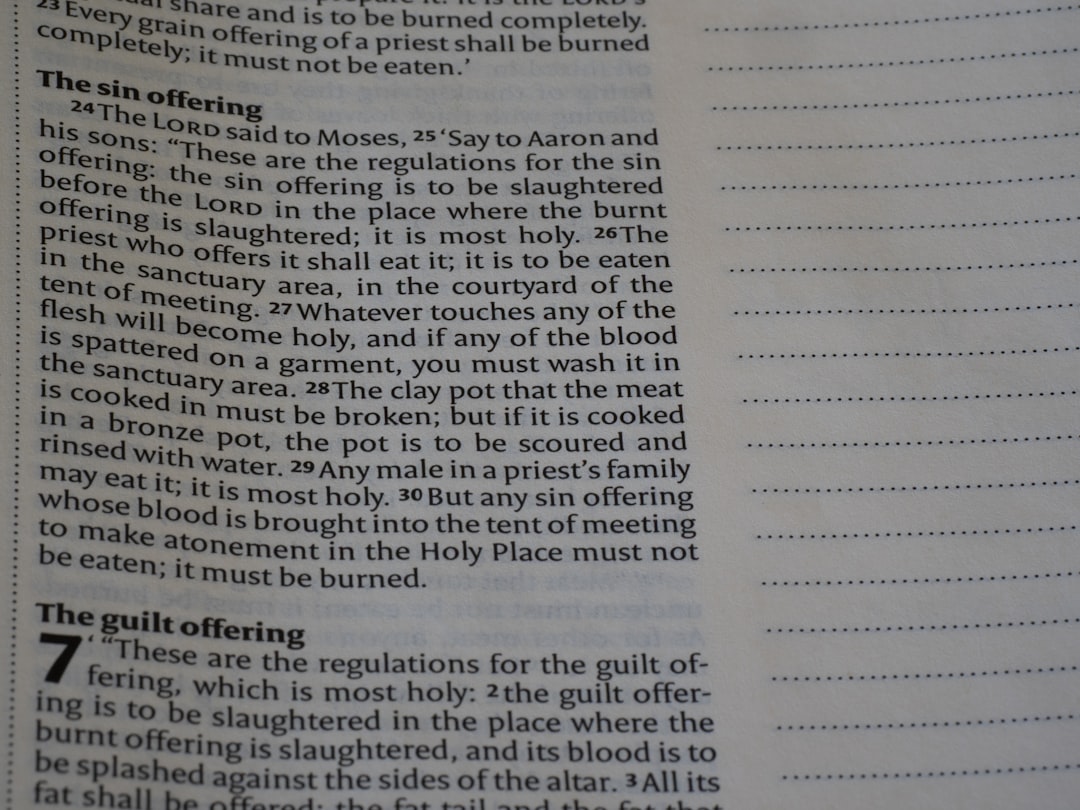 Close-up of open book with text and blank lines.