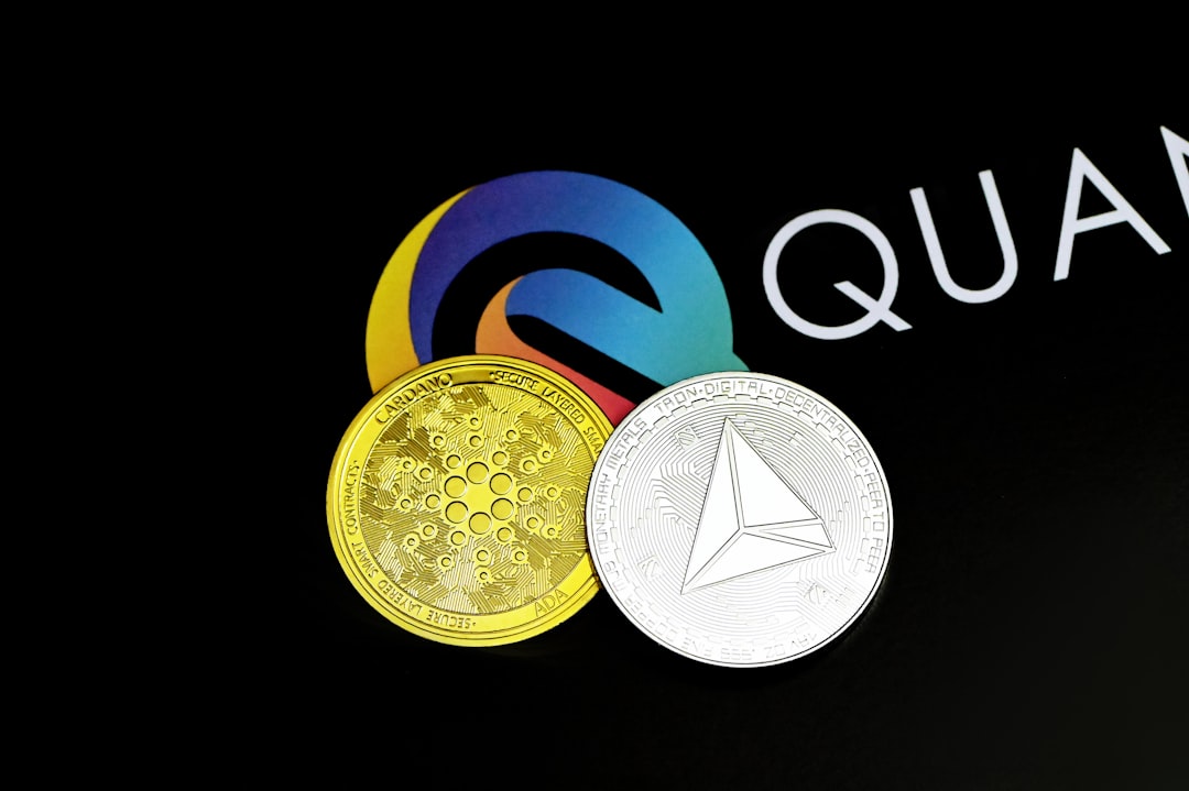 a close up of a coin with a logo in the background