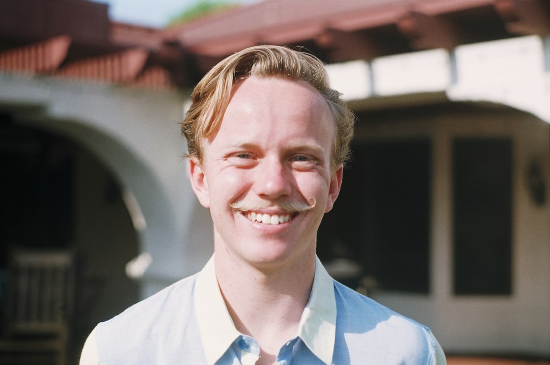 smiling man in white collared shirt