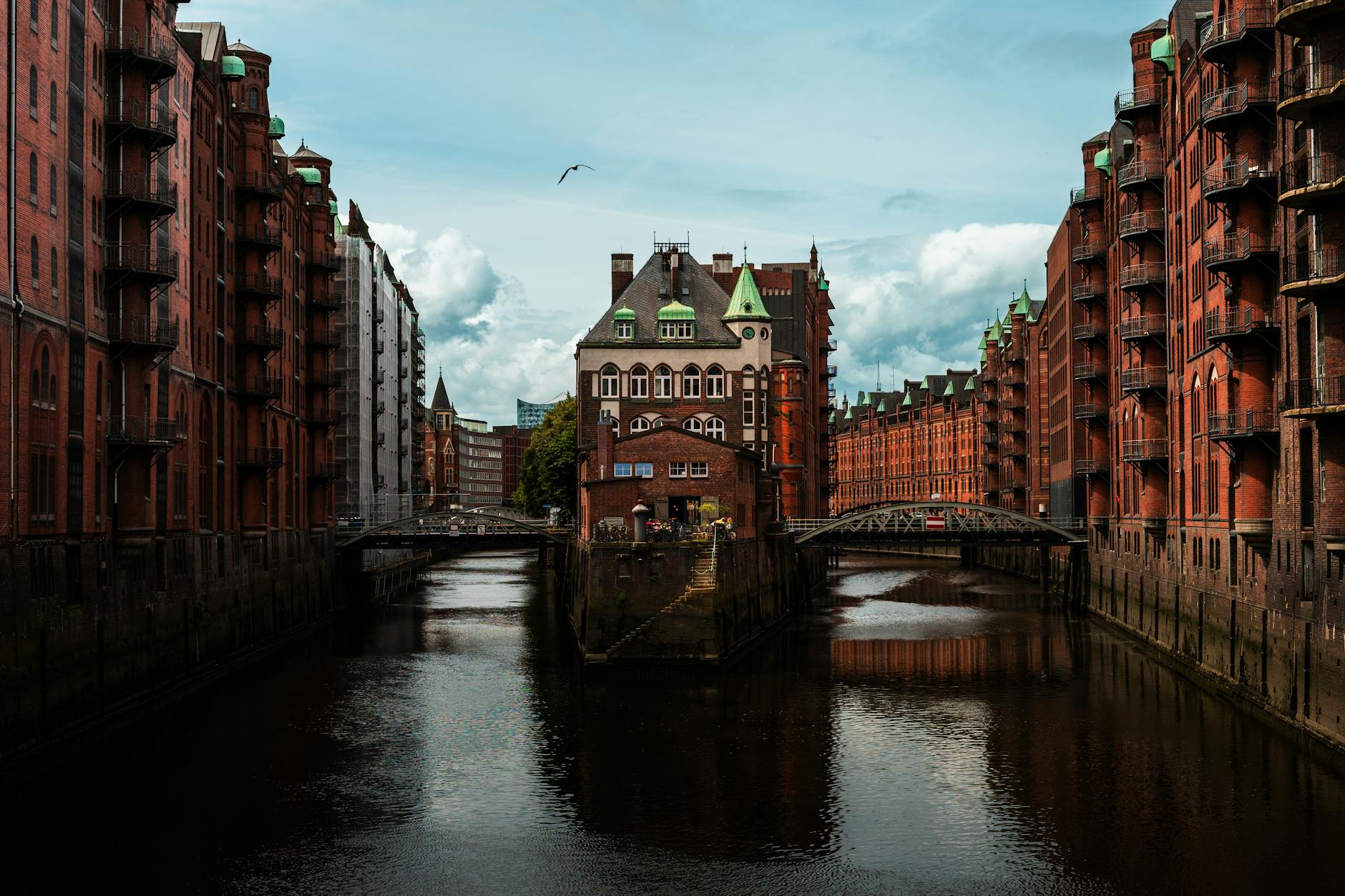Captivating view of red-brick buildings and canals in Hamburg's Speicherstadt warehouse district.