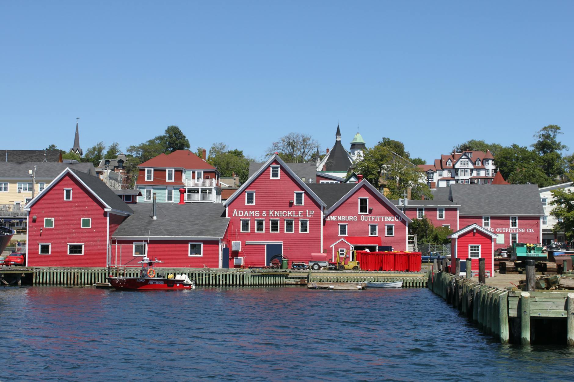 Historic waterfront view featuring red buildings in Lunenburg, Nova Scotia.