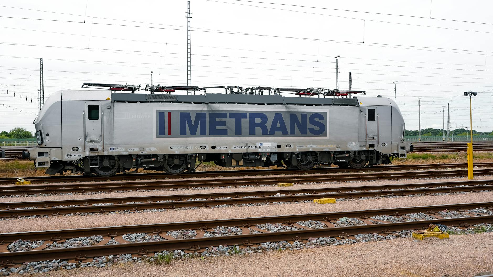 Side view of a Metrans electric train on the railway tracks in Hamburg, Germany.