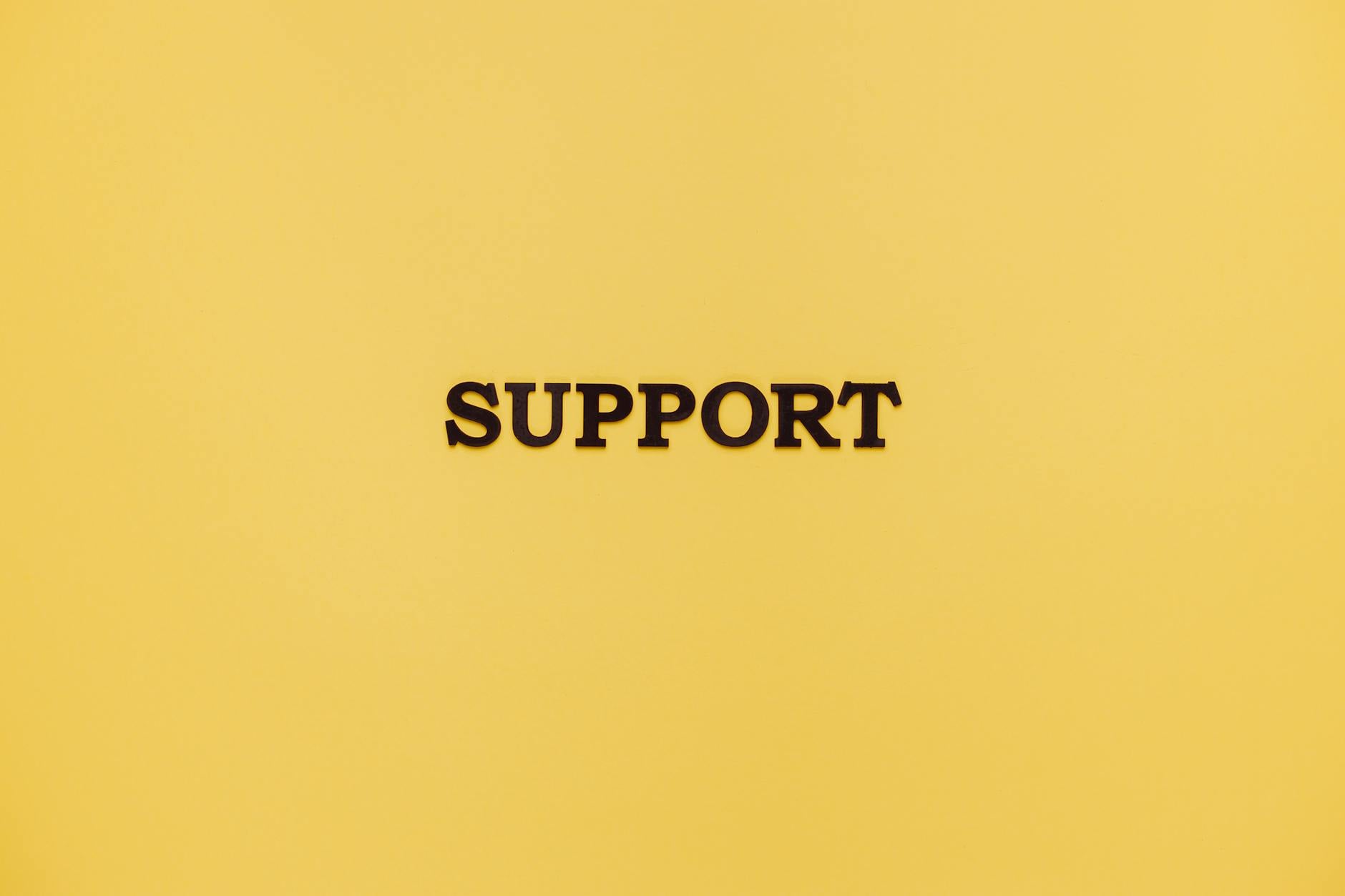 Minimalist image with 'Support' text on a yellow background for conceptual themes.